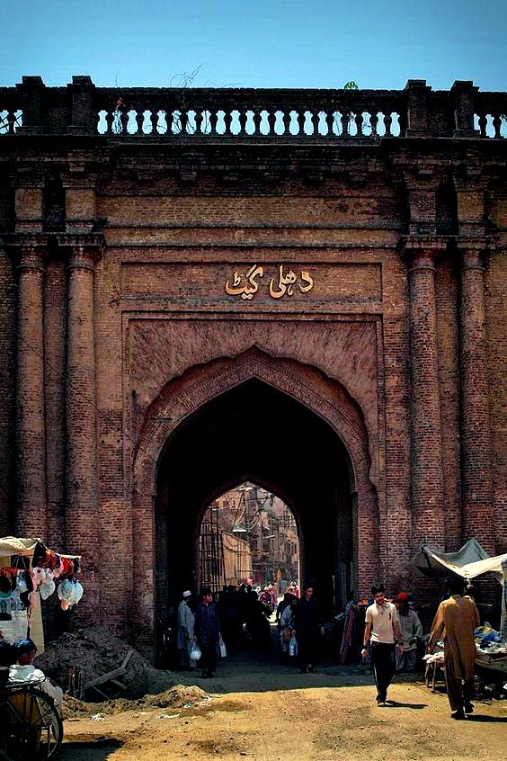 Delhi Gate in Lahore with red brick archway and bustling market street beyond