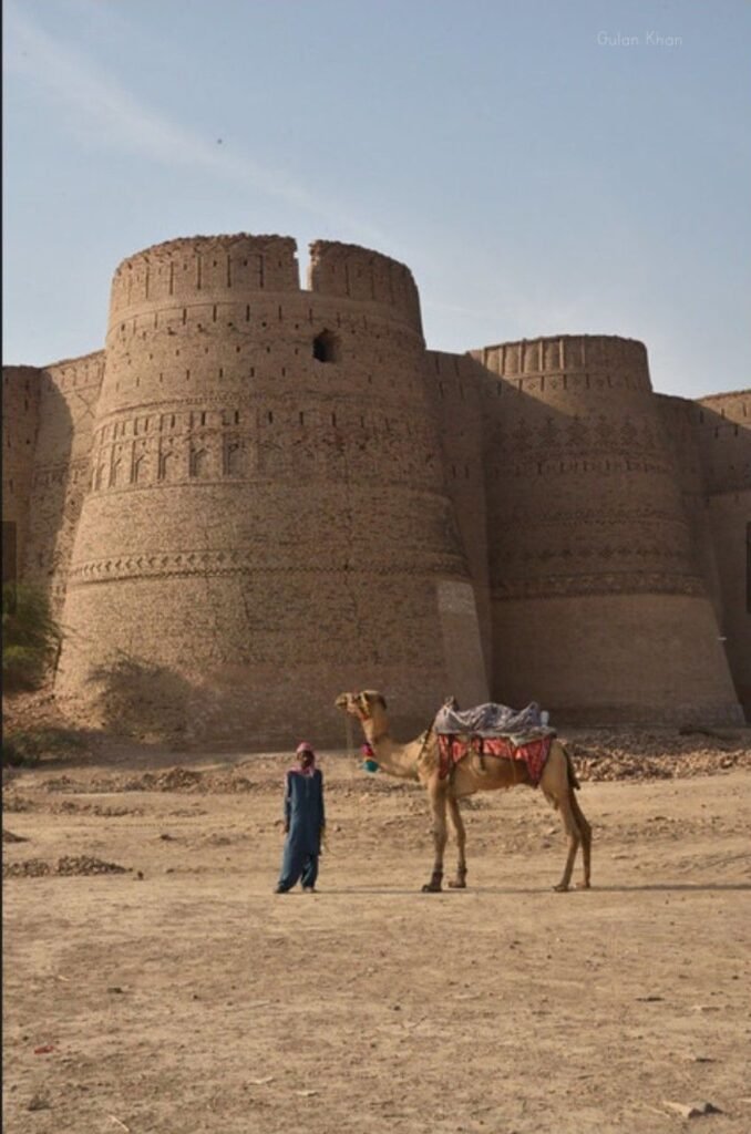 Cholistan Desert Safari: Tips, Guides, and Attractions 24 Cholistan Desert Safari featuring Derawar Fort with golden sand dunes and camel riders in Punjab, Pakistan.