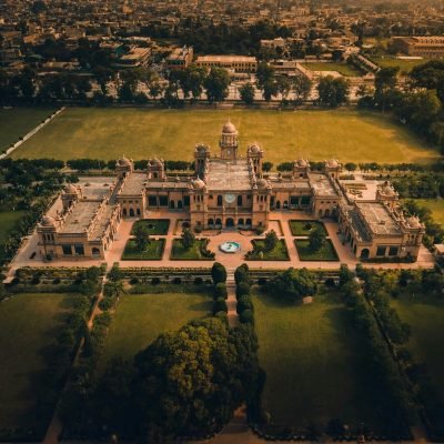 Aerial view of a grand domed building with gardens and fountain